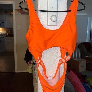 One piece stretch swimsuit with stomach open section but also sucks in stomach